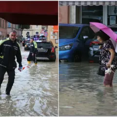 Uomini in divisa e una donna con ombrello camminano nell'acqua alta. Ecco cosa fare a San Benedetto del Tronto se piove: cercare riparo.