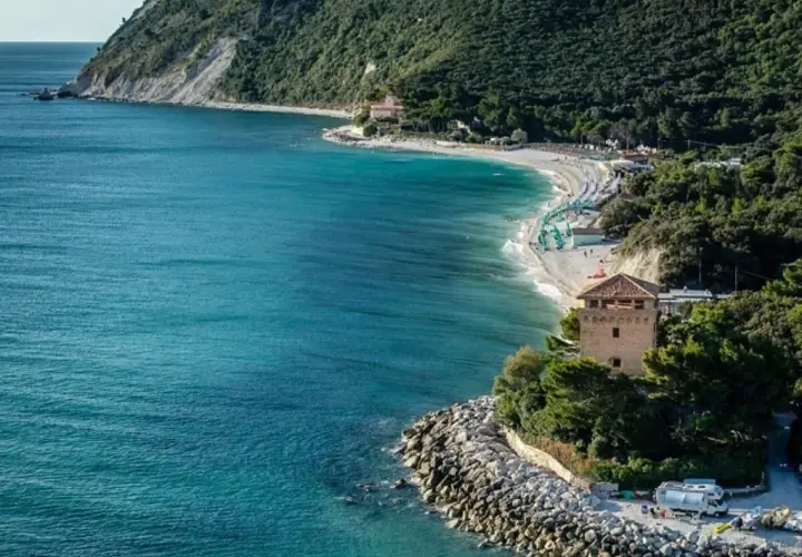 Ancona mare: una baia con spiaggia attrezzata, torre medievale e mare cristallino.