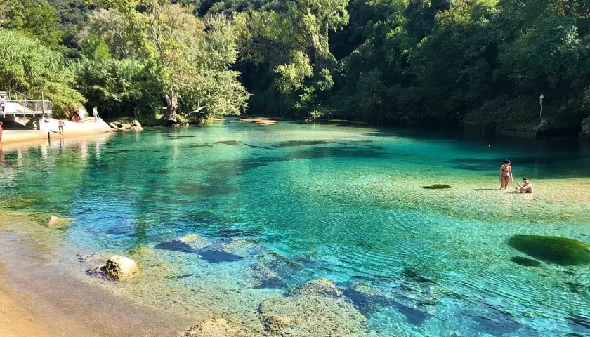 Acque cristalline e natura rigogliosa allo **stifone Mole di Narni**. Persone si godono il sole e il fresco in questo paradiso naturale.