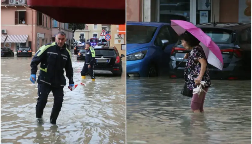 Uomini in divisa e una donna con ombrello camminano nell'acqua alta. Ecco cosa fare a San Benedetto del Tronto se piove: cercare riparo.
