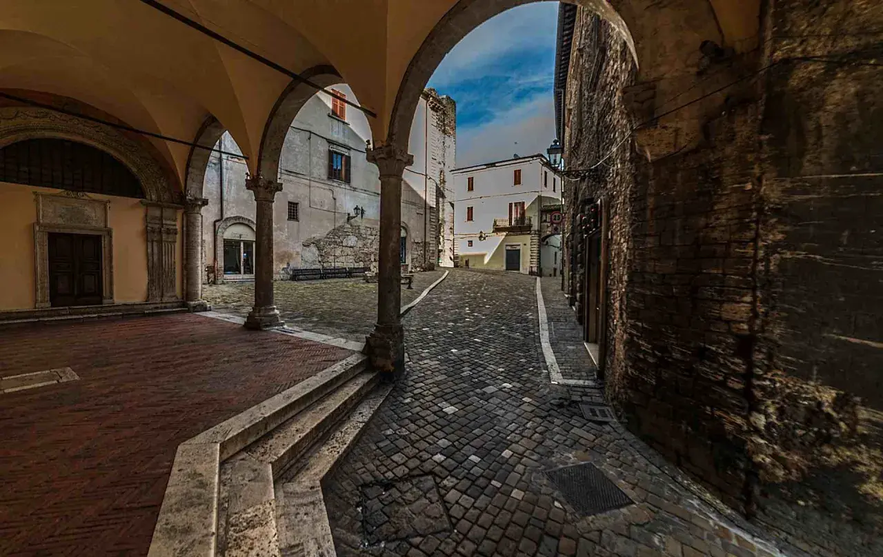 Arco medievale con vista su vicolo lastricato e case antiche. Un assaggio di cosa vedere a Narni, tra storia e fascino.