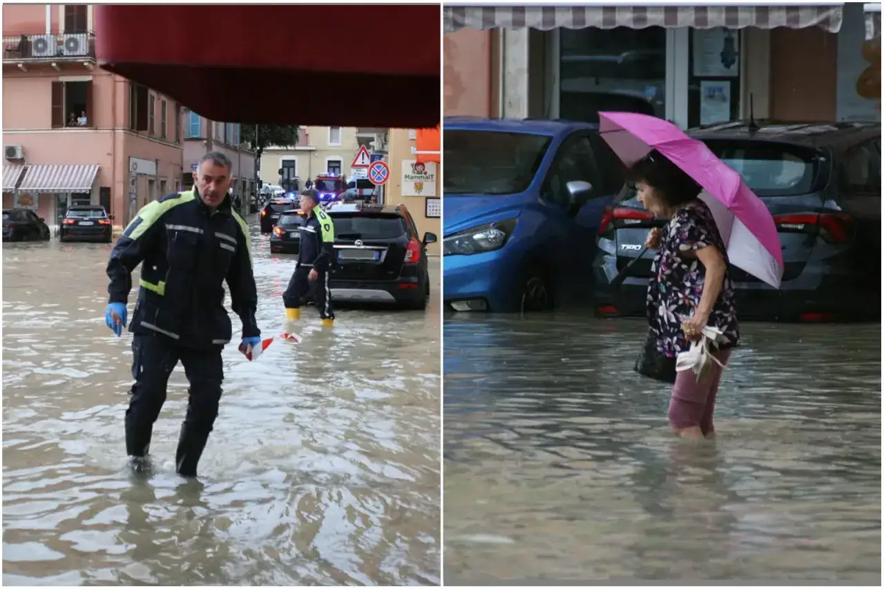 Uomini in divisa e una donna con ombrello camminano nell'acqua alta. Ecco cosa fare a San Benedetto del Tronto se piove: cercare riparo.